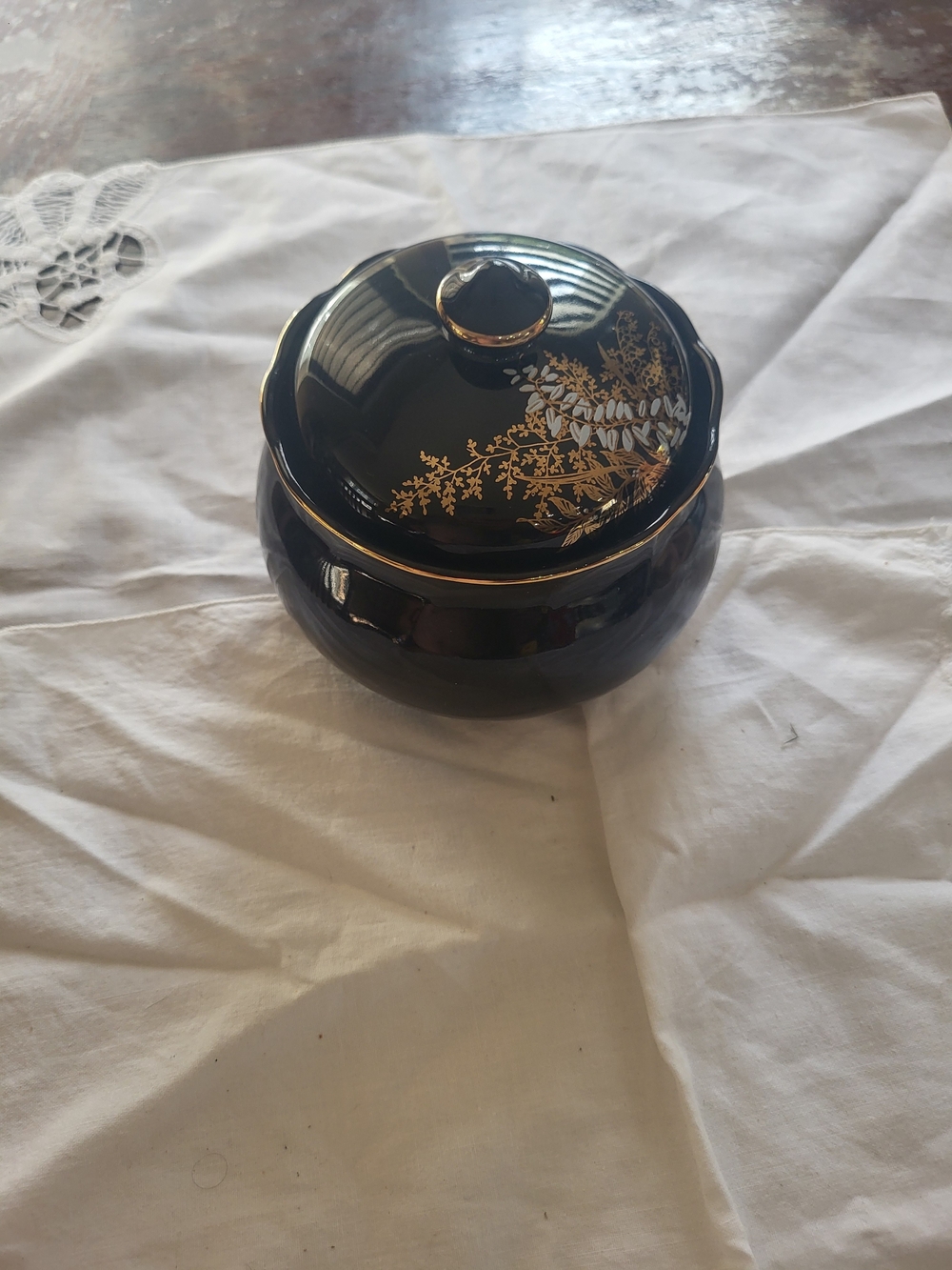 vintage black ceramic lidded trinket box, accented with delicate gold trim and a